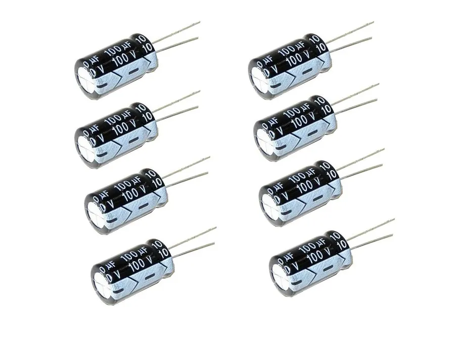 A collection of various 100uF capacitors including electrolytic, ceramic, and tantalum types.