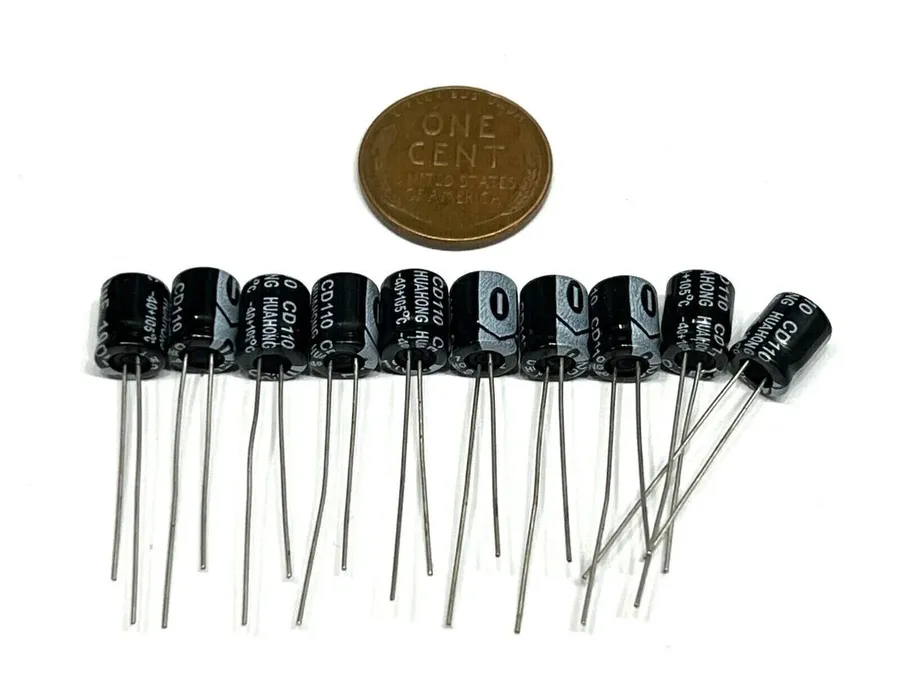 An electrolytic 100uF capacitor with its typical cylindrical shape.