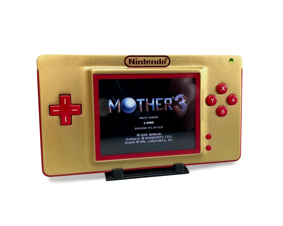 A modified Game Boy Macro with visible electronic components.