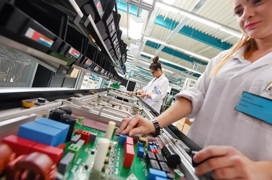 A photo of a PCB manufacturing facility with various machines.