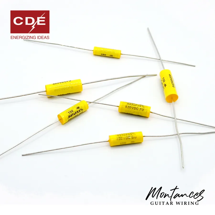 A guitar circuit board with Mallory capacitors visible.