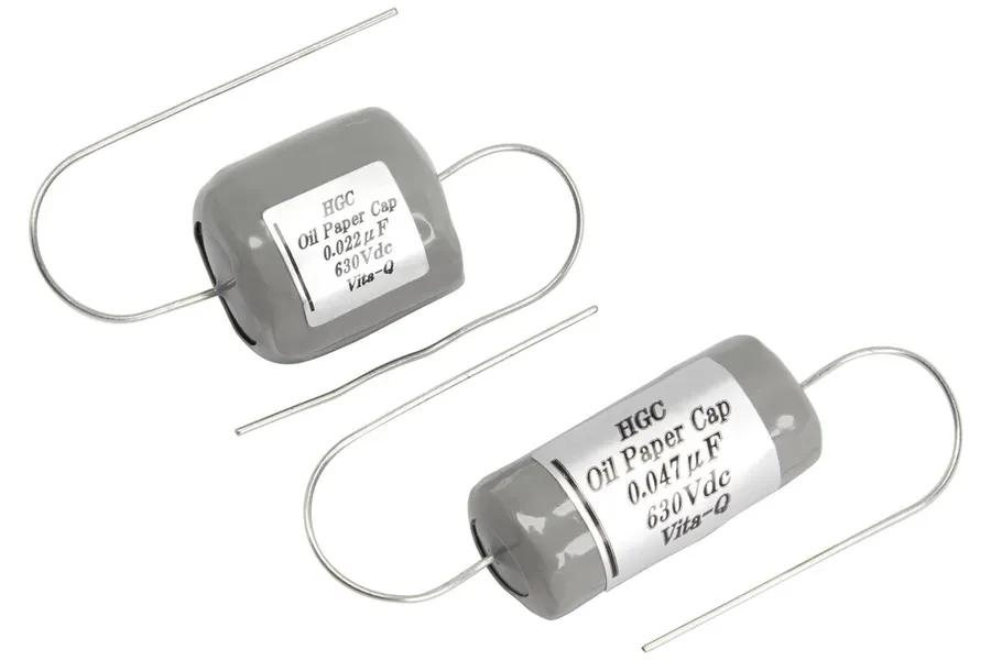A vintage paper-in-oil capacitor with its outer casing.