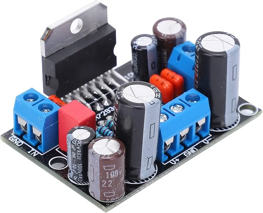 A circuit board with a 1 microfarad capacitor used in audio applications.