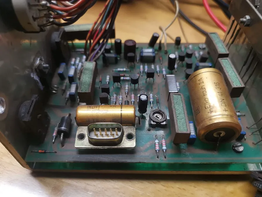 Several axial capacitors soldered on a circuit board.