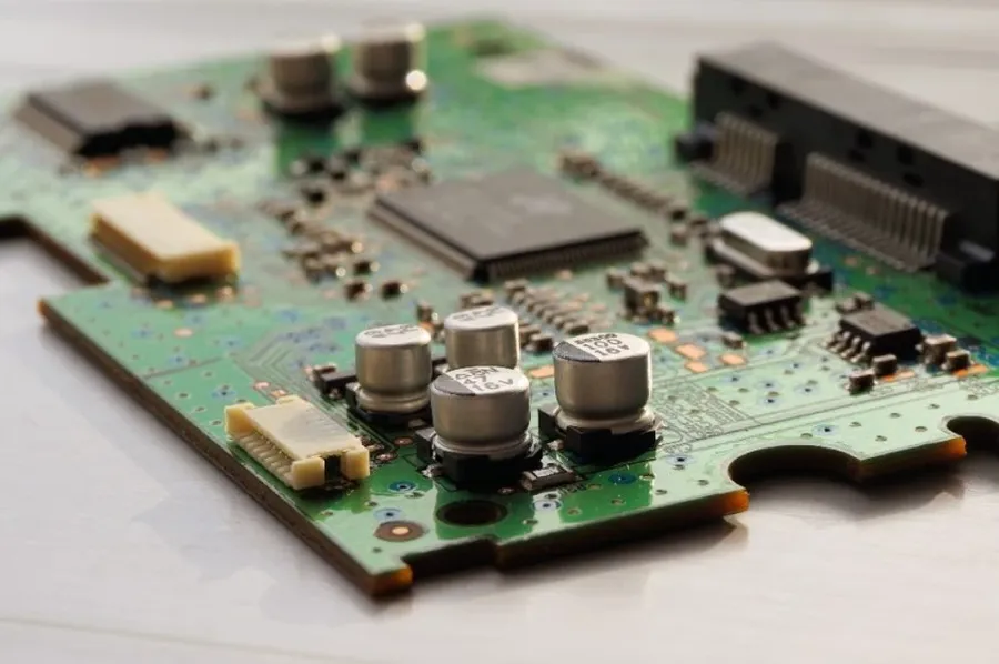 A hand selecting a resistor from a component organizer.