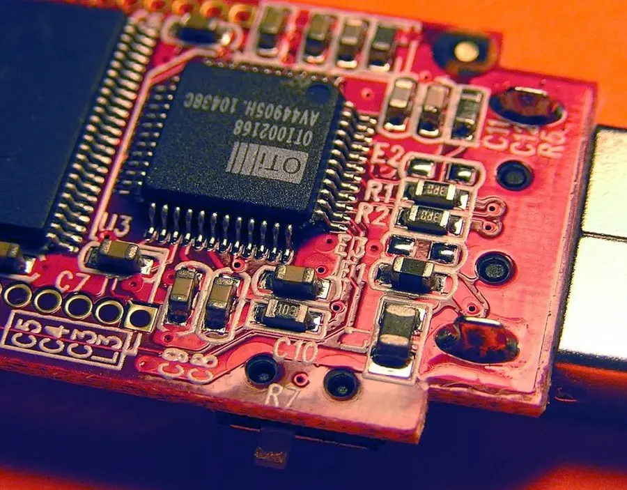 SMT equipment in action, placing components on a PCB.