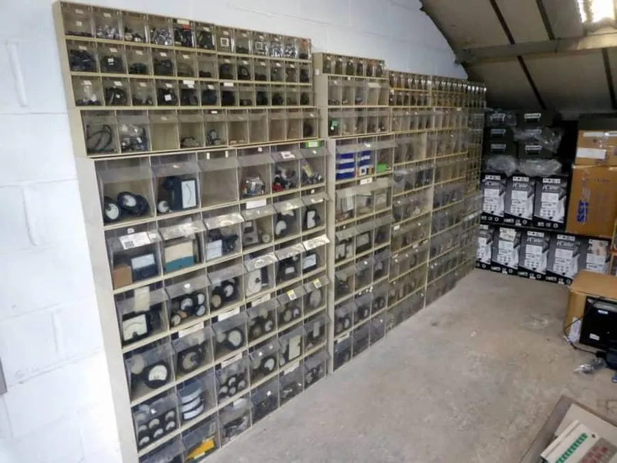 A large warehouse filled with shelves containing various electronic components.