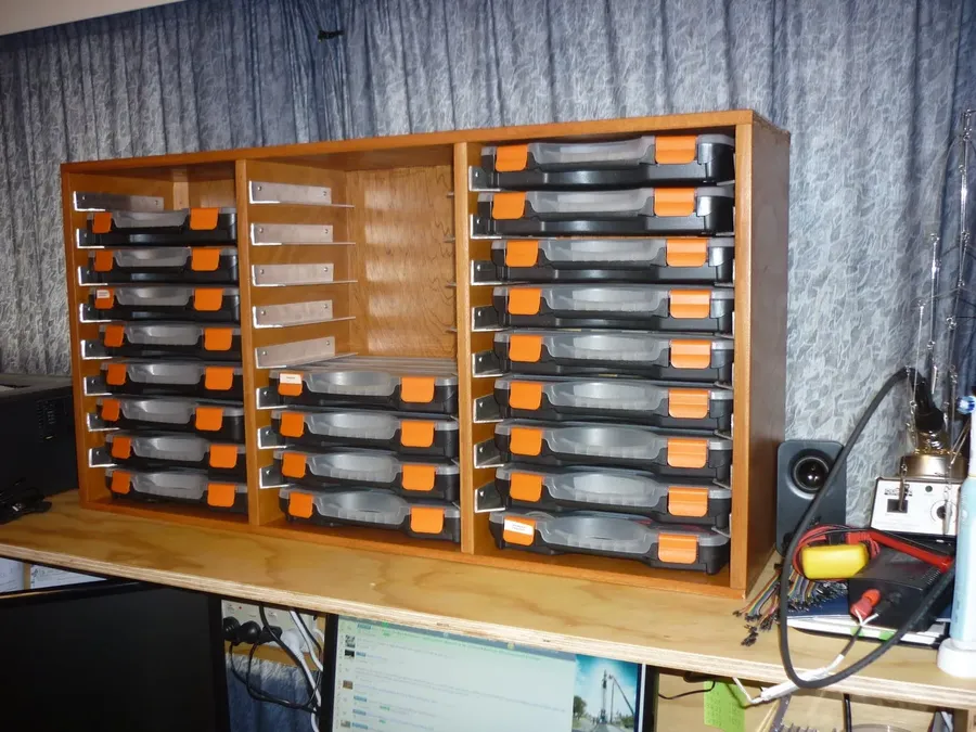 A shelf in an electronics component store with various capacitors on display.
