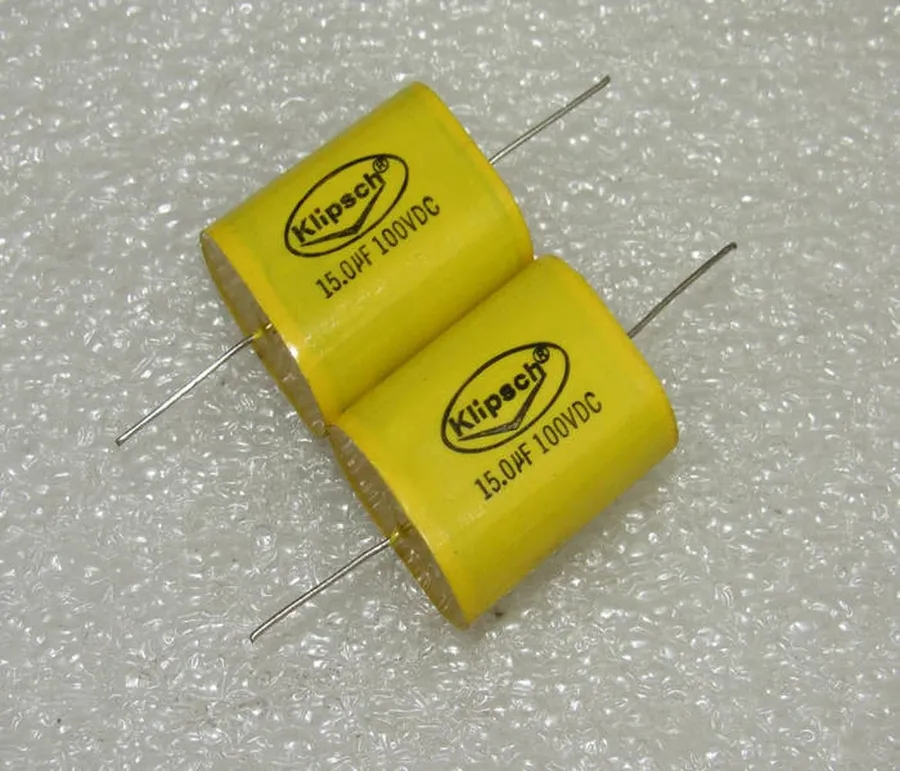A person replacing a 15uf capacitor on an electronic circuit board.