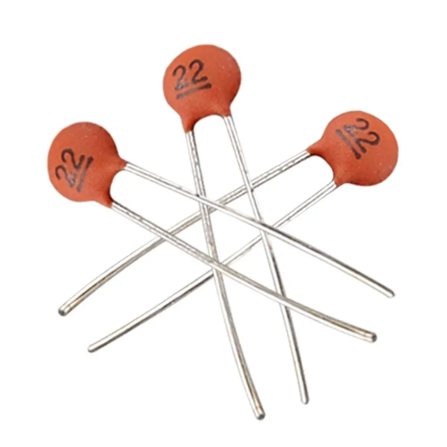 A close-up of small disc-shaped ceramic radial capacitors.