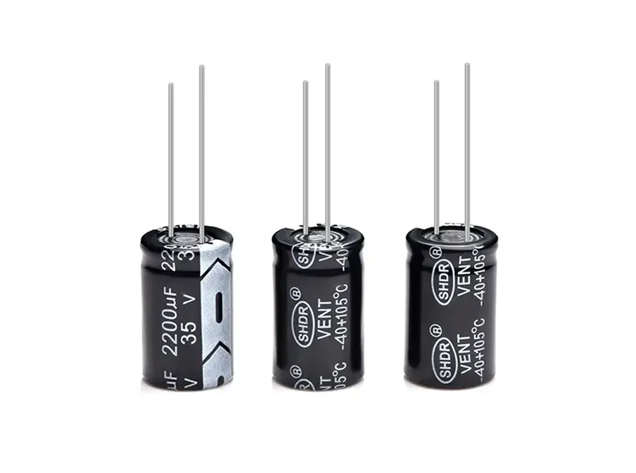 A close-up of several radial capacitors with different colors and sizes.