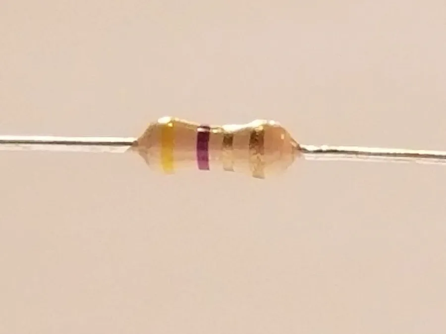 A close-up of a 4.7 ohm resistor.