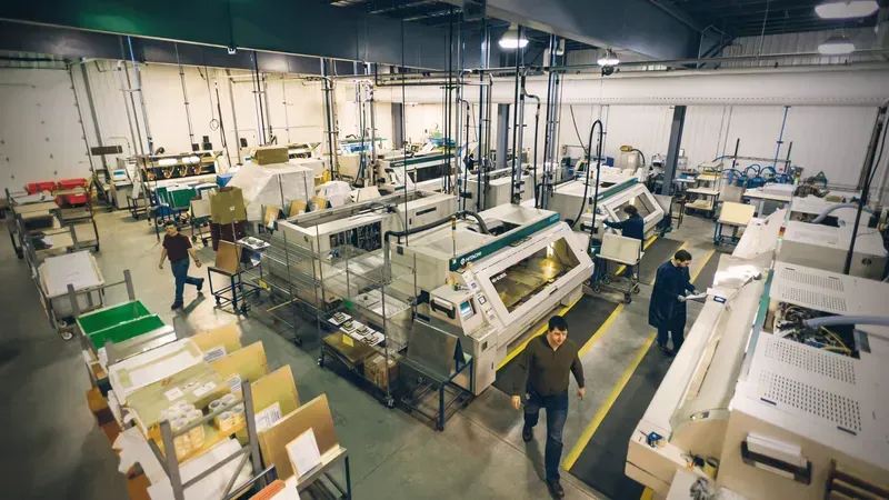 A wide shot of a PCB manufacturing facility with machinery