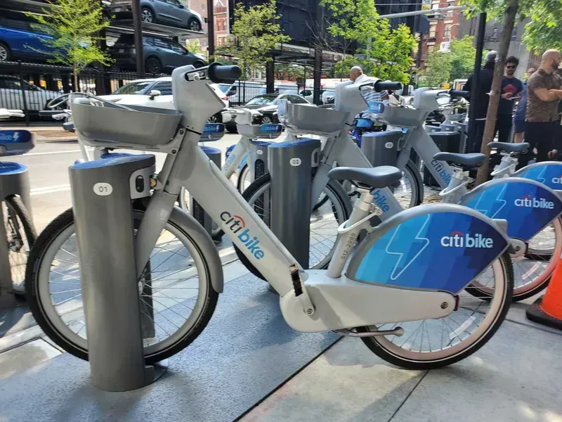 A fleet of electric bicycles being charged at a station