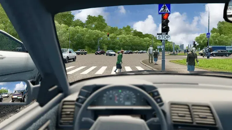 A person sitting in a driving test simulator