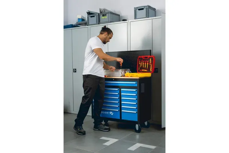 A factory worker retrieving a tool from a smart tool cabinet