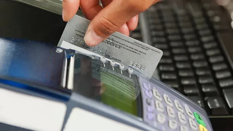 A factory worker swiping a card to access a tool cabinet