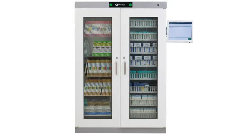 A factory employee taking a component from an open smart storage cabinet.