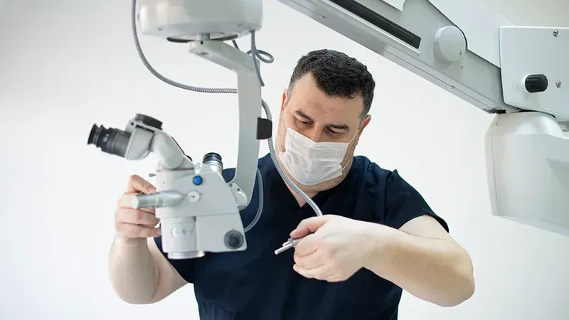 A technician performing maintenance on medical equipment in a hospital setting