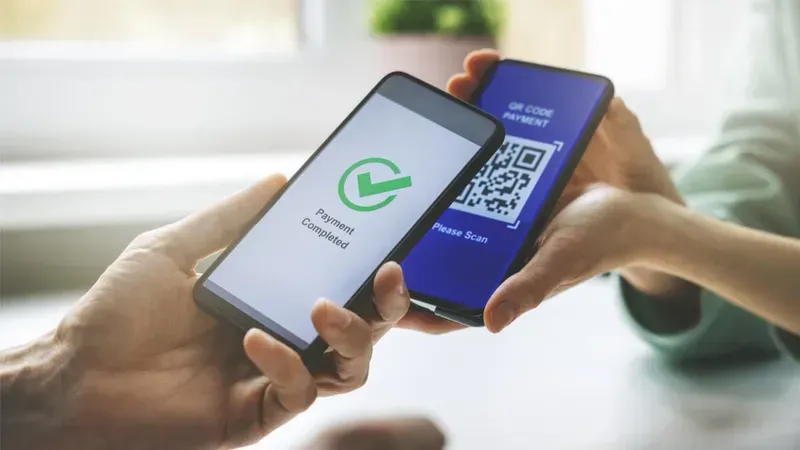 A person using a mobile phone to scan for payment