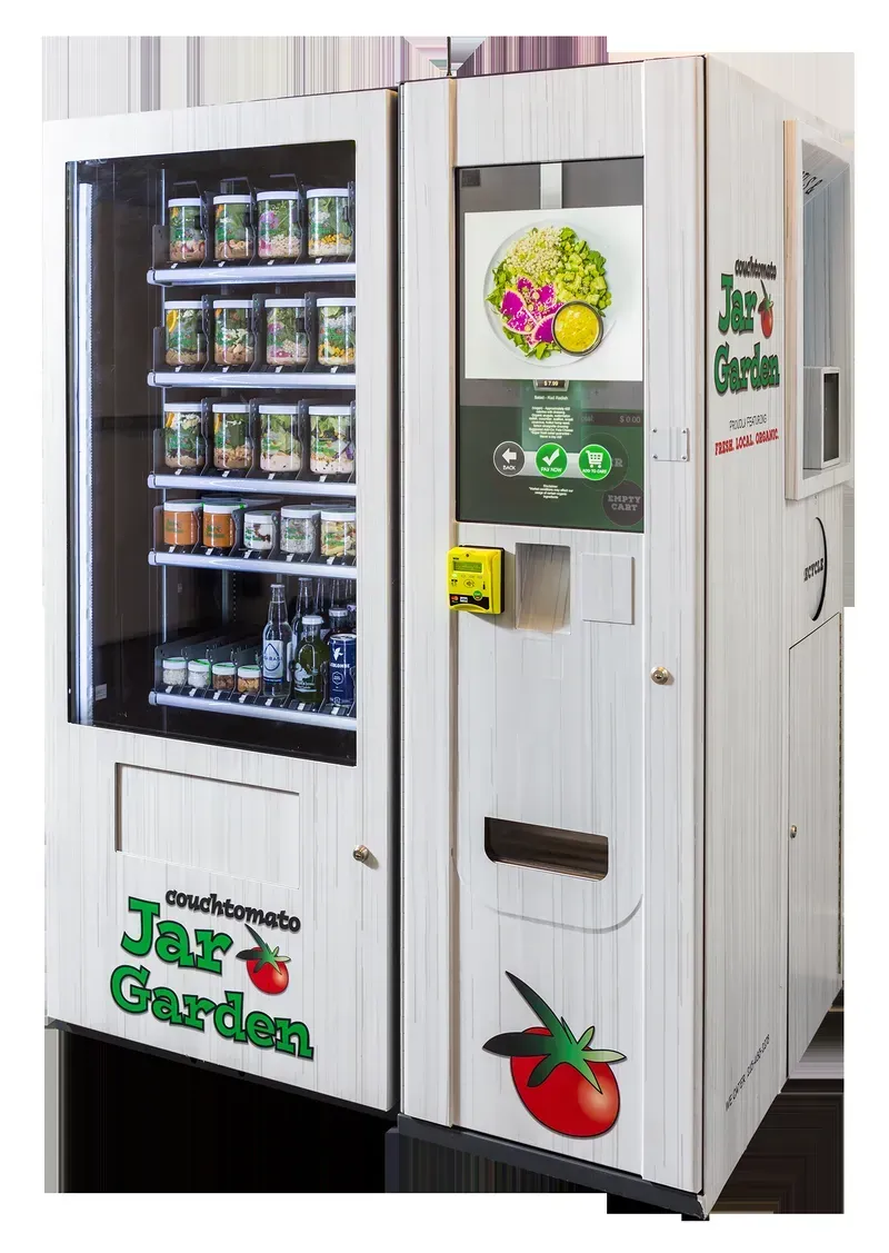 Workers assembling a custom vending machine on a production line