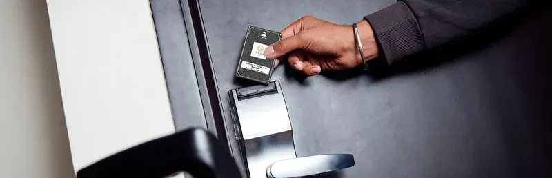 A person using a card to access a smart room