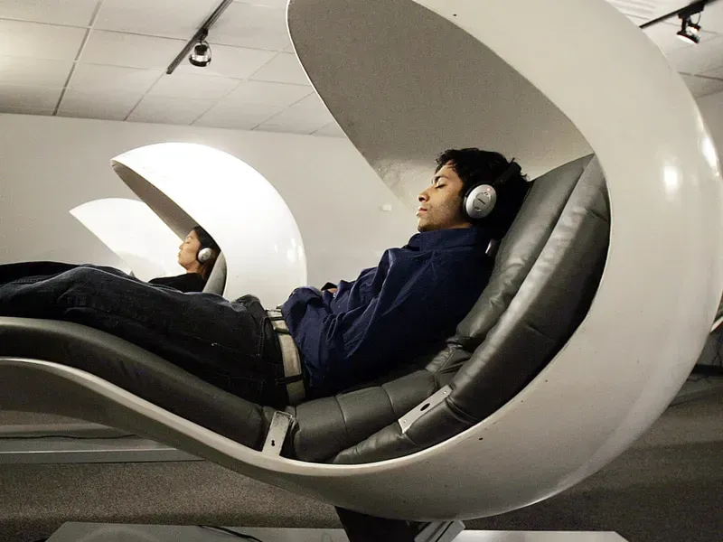 A person relaxing inside a futuristic sleep pod