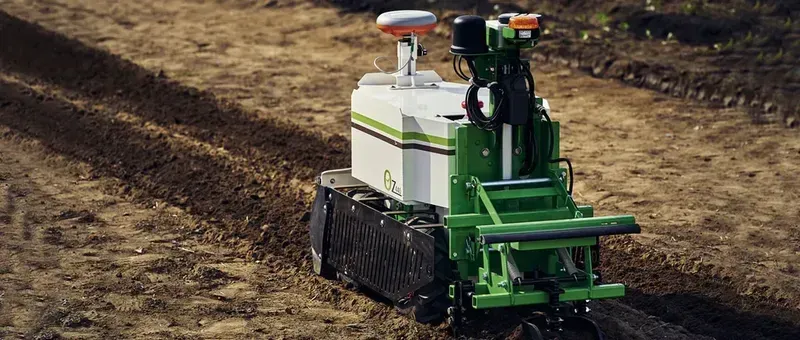 An agricultural robot tilling a field