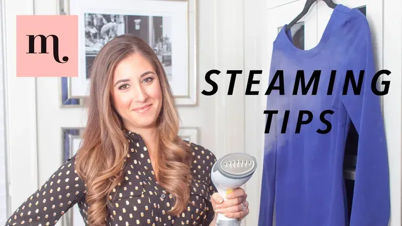 A person using a shared garment steamer to remove wrinkles from clothes