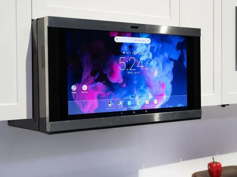 Close-up of a microwave oven with a touch screen interface.