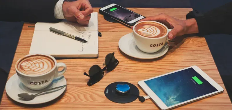 Wireless charging station in a cafe setting.
