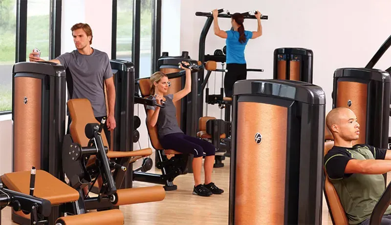A gym member using equipment with a tracking display
