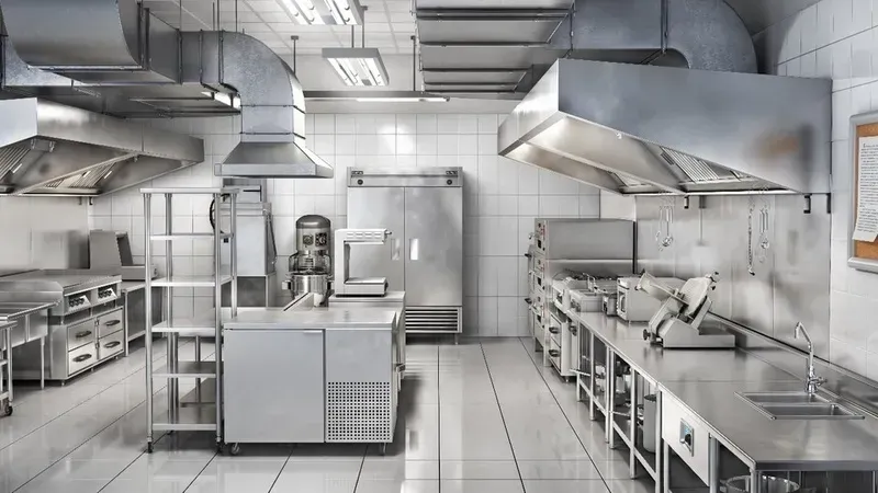 Various commercial kitchen equipment in a shared kitchen.