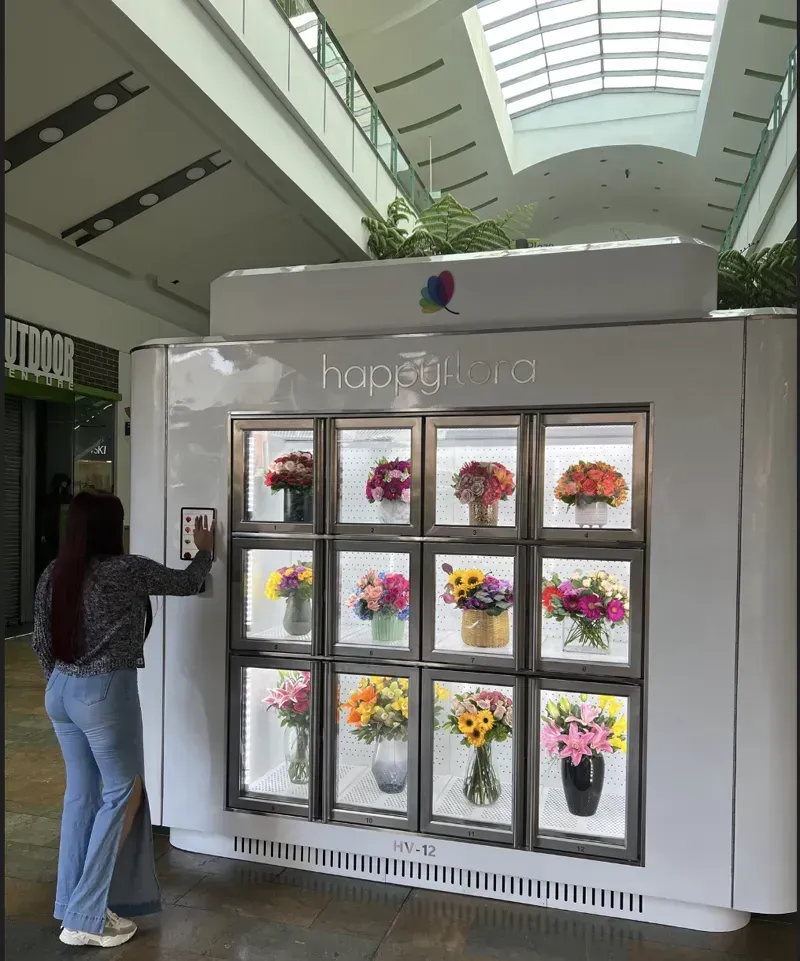 A modern self-service flower vending machine in a public setting