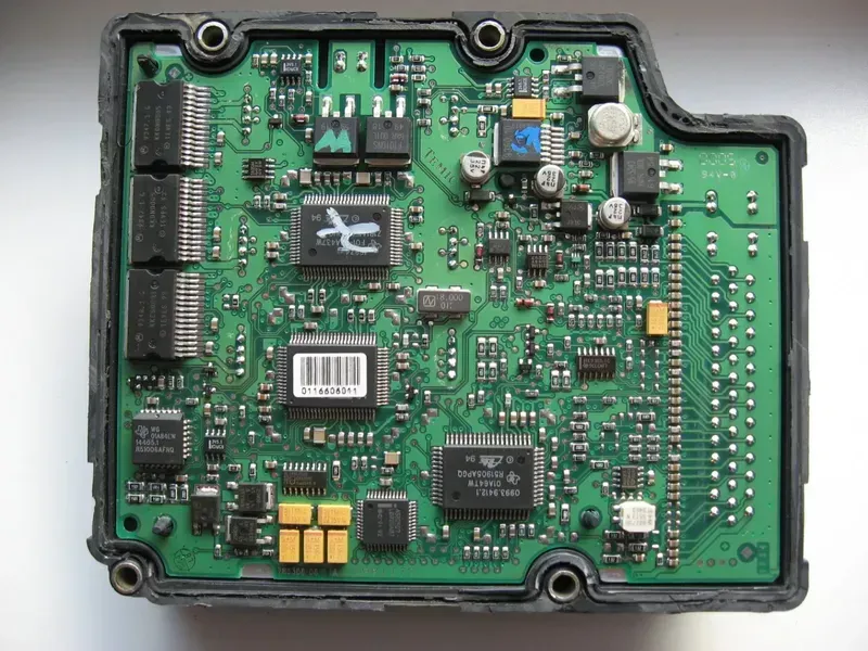 Technician inspecting a TPMS PCB