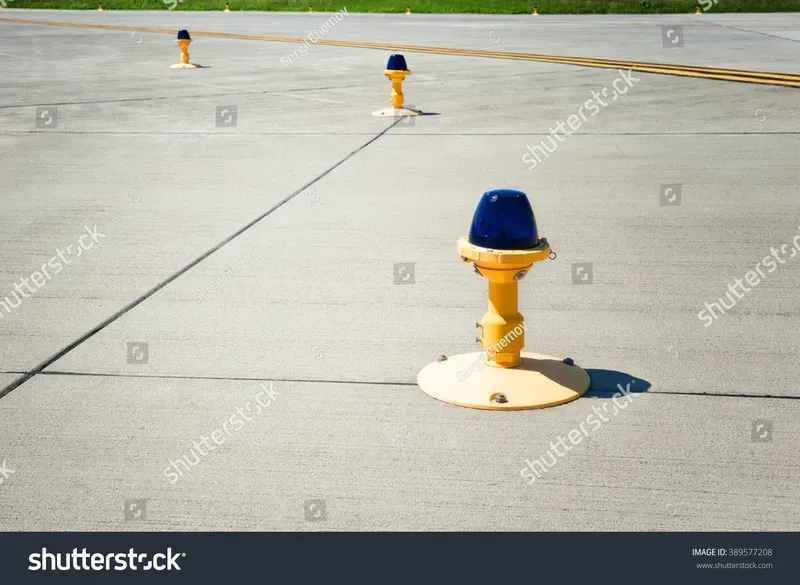 Close-up view of airport runway lights illuminating the tarmac
