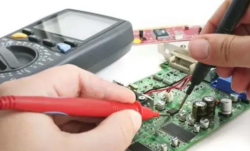 A technician performing quality testing on a PCB in a laboratory.