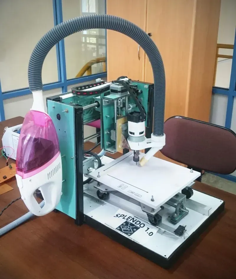 An engineer operating a PCB prototyping machine
