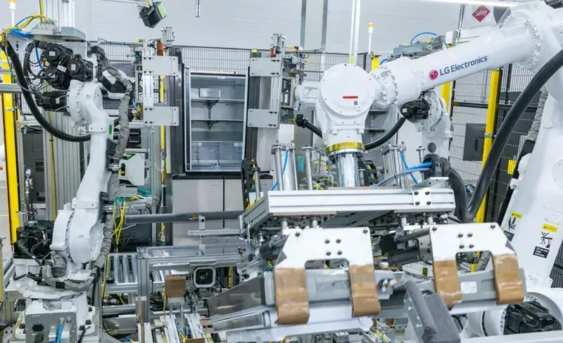 An automated electronics manufacturing line with robotic arms inspecting motherboards