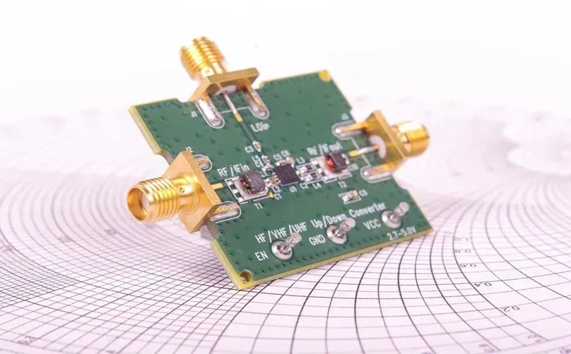 A technician performing RF testing on a circuit board using specialized equipment