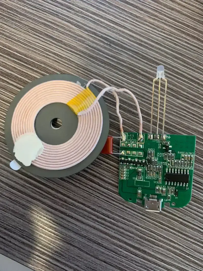 Testing equipment connected to a wireless charging board for quality assurance