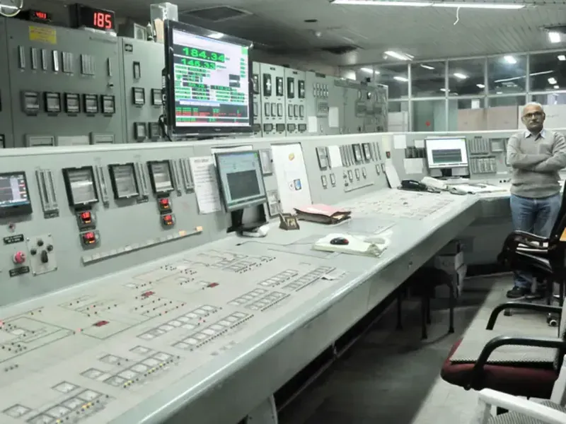 A detailed view of a control board inside a biomass power generation plant.