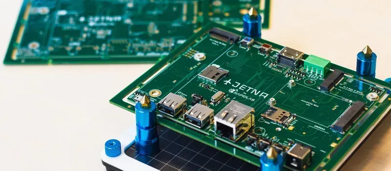 R&D engineer working on a circuit board prototype for EV charging