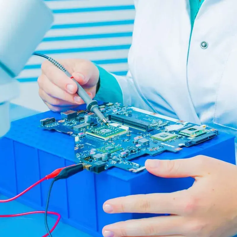 An engineer performing quality testing on a PCB board