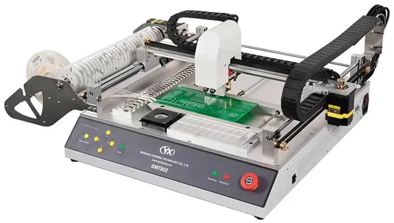 An automated machine performing PCB assembly, placing components onto a circuit board