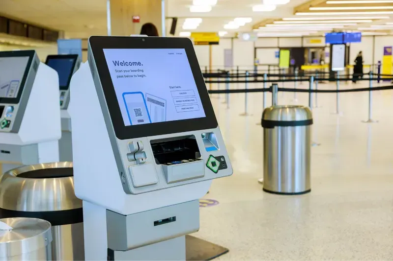 A person using a visitor management terminal at an office entrance