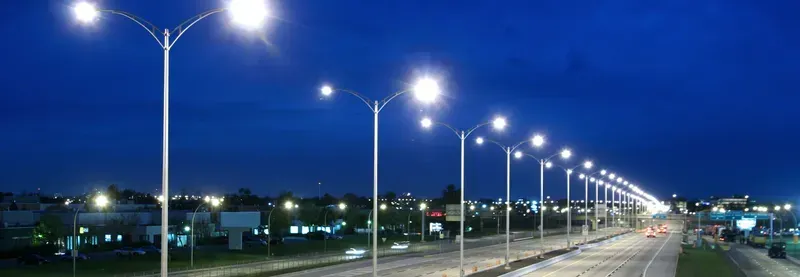 An installed smart street light illuminating a city street